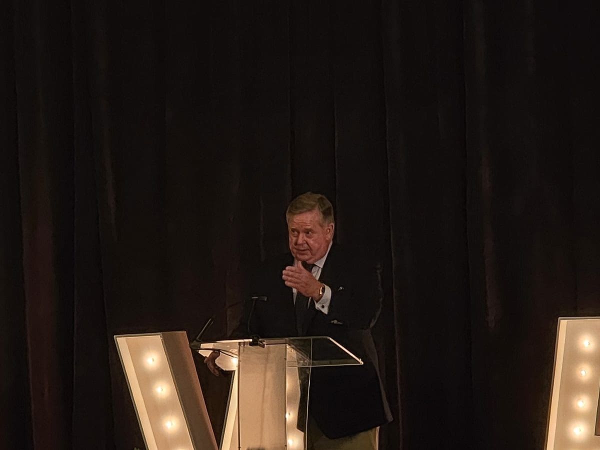 Speaker at event with illuminated letters