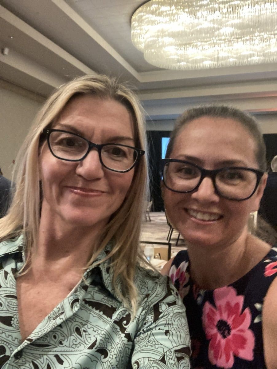 Two women smiling indoors