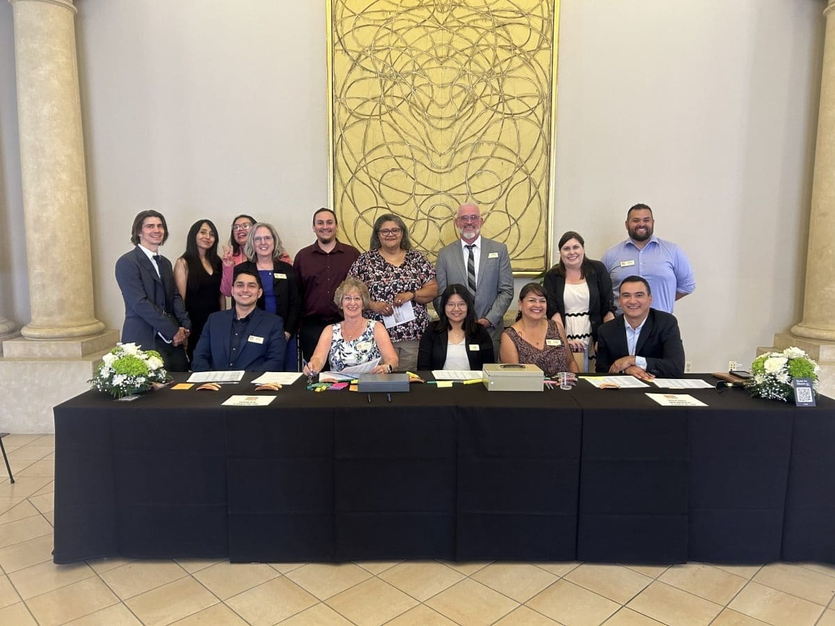 Group of people posing at a table