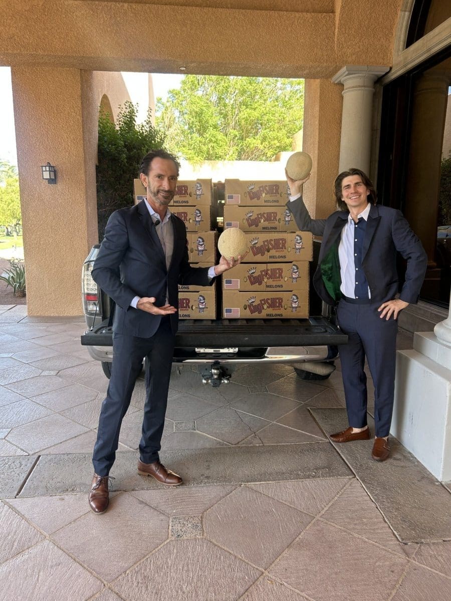 Men holding melons in suits