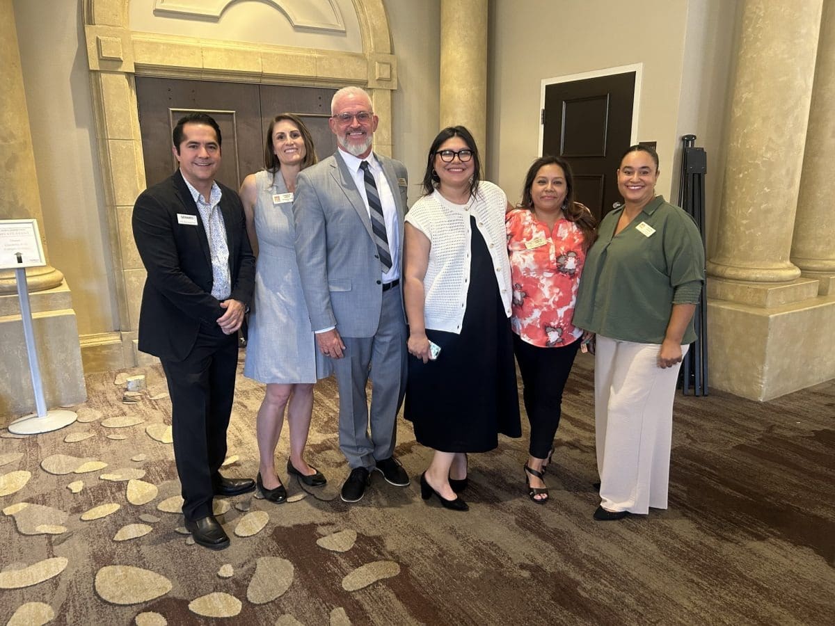 Business professionals standing together inside