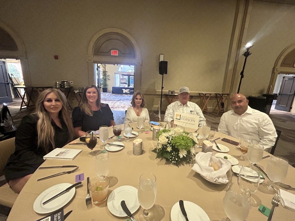Five people at a banquet table