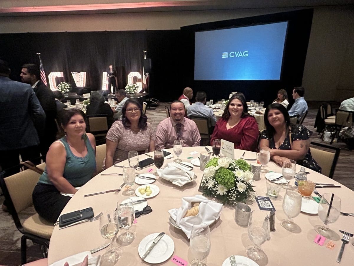 Group at banquet table with flowers